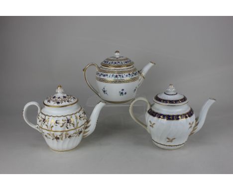 Two Worcester Flight period porcelain teapots, both of wrythen form, decorated in cobalt blue and gilt with floral and foliat