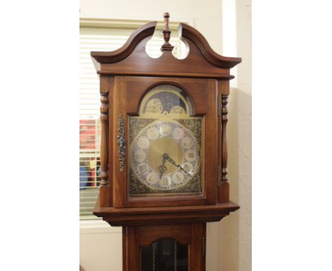 A reproduction mahogany longcase clock the brass sun and moon dial marked Emperor Clock Co Ltd, over a glazed door on plinth 