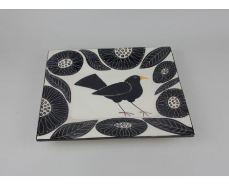 A rectangular glazed ceramic dish by Helen Brown, decorated with a blackbird amongst stylized black flowers on white ground 3