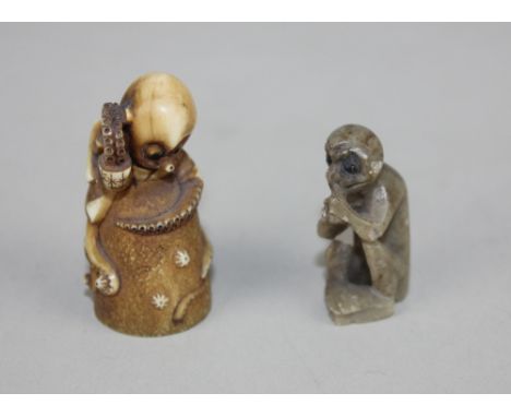 A Japanese netsuke in the form of an octopus hammering a rock containing another octopus, together with a miniature carved ha