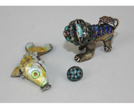 A Chinese white metal and enamel model of a dog of Fo, together with an enamel articulated fish pendant