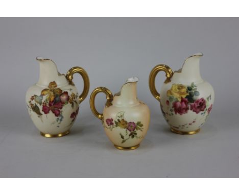 Three Royal Worcester blush ivory porcelain flat backed jugs, decorated with flowers and gilt embellishments, largest 13cm hi