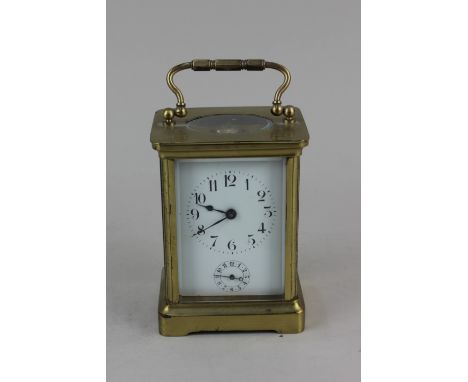 A brass carriage clock, the white enamel dial with Arabic numerals and subsidary dial, 11cm high, with key