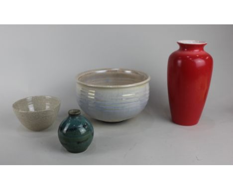 A Poole pottery red glazed vase, 21cm high, together with a studio pottery bowl with iridescent glaze, indistinctly signed, 1