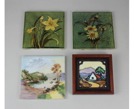 Two early 20th century Pilkington's tiles decorated with daisies and daffodils on green glazed ground 15.5cm by 15.5cm, a fra
