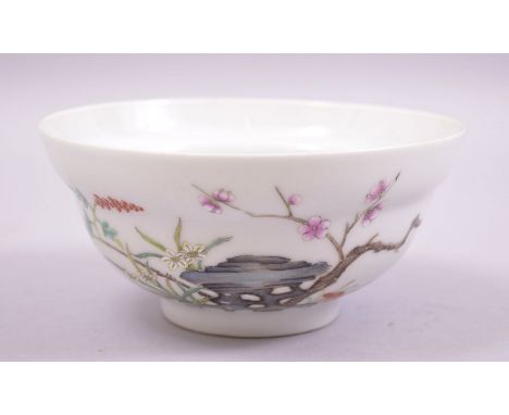 A GOOD CHINESE FAMILLE ROSE PORCELAIN TEA BOWL, decorated with a bird and native flora, with six character mark to base, 12.5