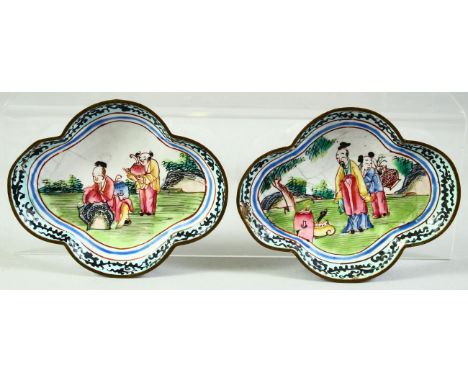 A SMALL PAIR OF CHINESE QUATREFOIL FORM ENAMEL DISHES, painted with figures in a garden, 9cm x 7.5cm.
