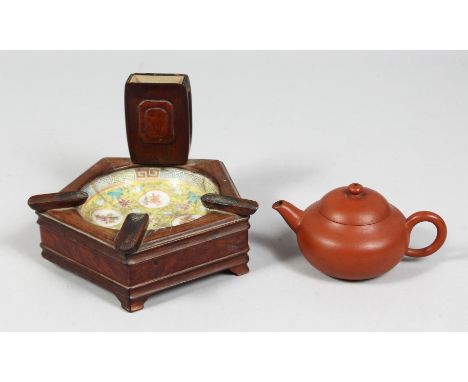 AN EARLY 20TH CENTURY CHINESE FAMILLE JAUNE DISH inset within a wooden ashtray, together with A SMALL YIXING TEAPOT with inci