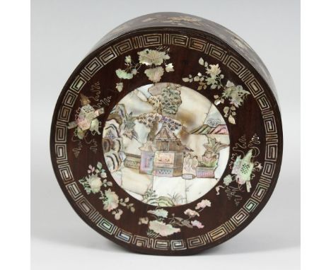 A CHINESE MOTHER OF PEARL INLAID HARDWOOD CIRCULAR BOX, the lid with central mother of pearl panel depicting an outdoor scene