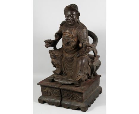 A SUPERB LARGE CHINESE CARVED WOOD STATUE of a seated dignitary, mounted to a wooden base, the figure carved with ceremonial 