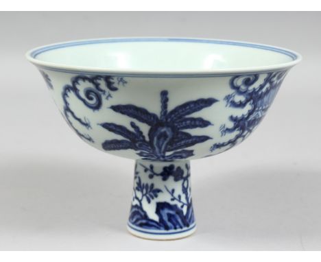 A CHINESE BLUE AND WHITE PORCELAIN STEM CUP, the exterior decorated with female figures in a garden setting, the interior of 