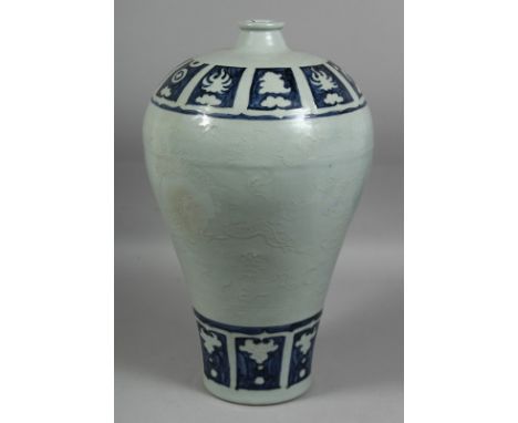 A LARGE CHINESE BLUE AND WHITE PORCELAIN MEIPING VASE, the body with relief linework decoration depicting a dragon amongst st