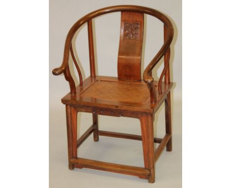 A GOOD CHINESE ELM WOOD HORSESHOE SHAPE CHAIR, with carved back splat and woven seat panel, 94cm high.