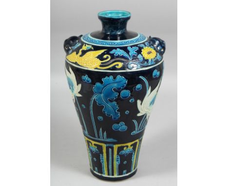 A CHINESE FAHUA MEIPING PORCELAIN VASE, with raised decoration of flora and phoenix, the shoulder with twin lion handles. 33c