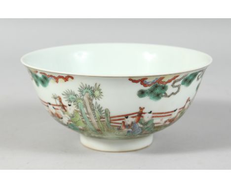 A CHINESE FAMILLE VERTE PORCELAIN BOWL decorated with children in a garden, the base with a six-character mark. 16cm diameter