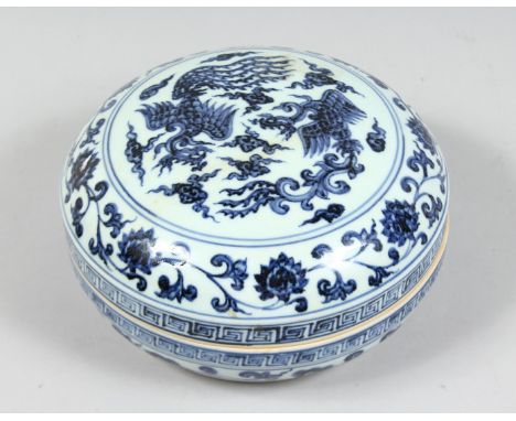 A CHINESE BLUE AND WHITE PORCELAIN CIRCULAR BOX AND COVER, decorated with phoenix and lotus, the rim of cover bearing a six c