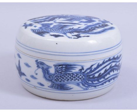 A CHINESE BLUE AND WHITE CYLINDRICAL PORCELAIN PHOENIX BOX AND COVER, decorated with phoenix and objects, the base with chara