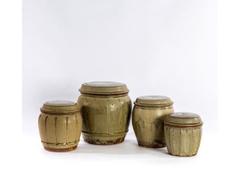 Mike Dodd (British, born 1943), four celadon glazed storage jars and covers, the largest 22cm high (one with cracked cover) C