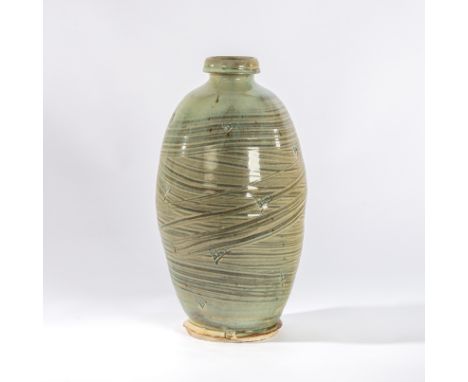 Mike Dodd (British, born 1943), a large celadon glaze bottle vase with thickly brushed hakeme glaze and occasional incised pa