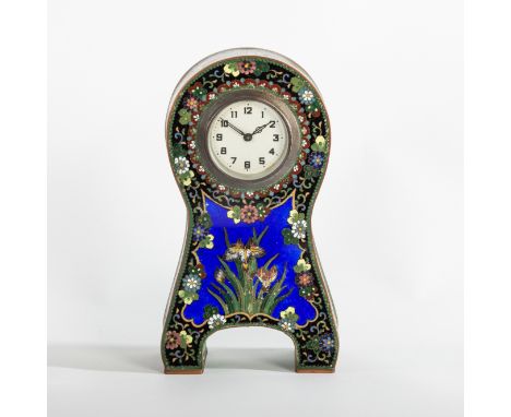 A cloisonne enamel cased clock, of cartouche shape, decorated in the Aesthetic style, the front with irises on a cobalt blue 