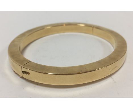 A Continental gold bangle of flattened circular form