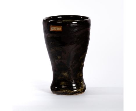Shoji Hamada (Japanese 1894-1978), a stoneware beaker of cylindrical tapering form, in dark mottled tenmoku glaze , 19.5cm hi