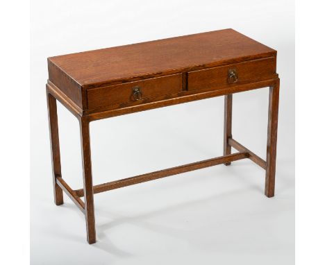 Cotswold School, an Arts and Crafts oak writing table, circa 1900, fitted two drawers with brass ring handles, the base with 