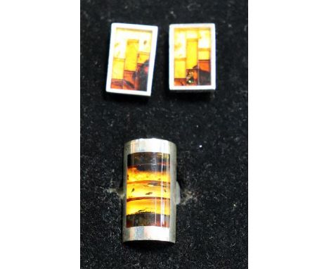 An American silver modernist ring and earring set, the ring with curved rectangular panel set with bands of amber, the earrin