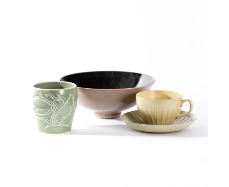 Susie Cooper, a green glaze jar with pressed floral design, 9cm high, a Wedgwood cup and saucer of ribbed form in yellow glaz