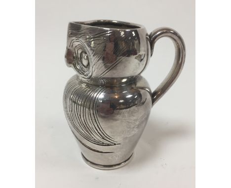 Style of Archibald Knox, a silvered ceramic jug in the form of an owl, 14cm high