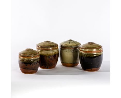 Richard Batterham (British, born 1936), four stoneware lidded caddies, ash and tenmoku glazes, two with star design to lid, 1