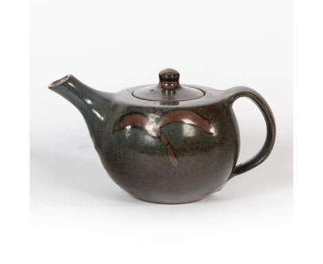 Geoffrey Whiting (British 1919-1988), a small teapot in dark blue glaze with rust foliate brush motifs, 11cm high/Provenance: