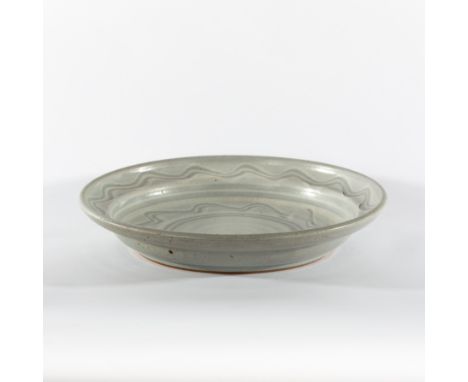 Paul Barron, a shallow circular bowl, pale blue glaze with wavy decoration, impressed B mark, 36cm diameter  CONDITION REPORT