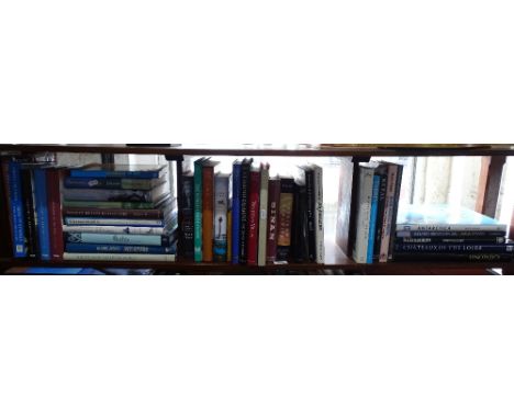 A shelf of books including botanical, travel and history.