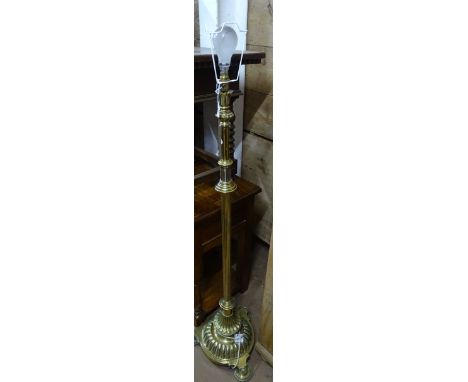 A brass telescopic standard lamp and shade.