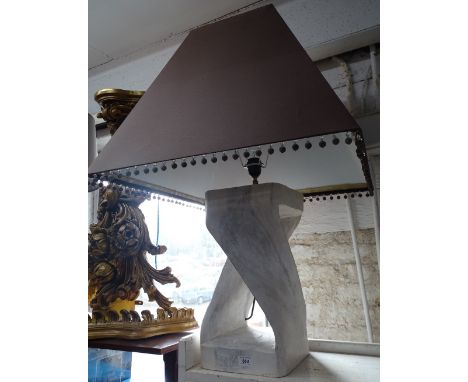 A large modern table lamp and shade.