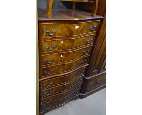 A reproduction mahogany chest on chest, of serpentine form with 8 drawers on bracket feet, width 2'6", height 4'9".