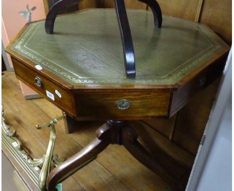 A mahogany octagonal centre table, having an inset green leather skiver and 4 frieze drawers, raised on turned centre column 