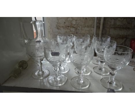 A set of engraved goblets, and a jug decanter.