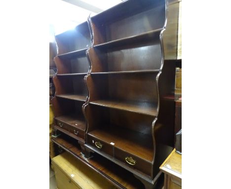 A pair of reproduction mahogany waterfall open bookcases, with drawers under on bracket feet, width 2'7", height 4'10".