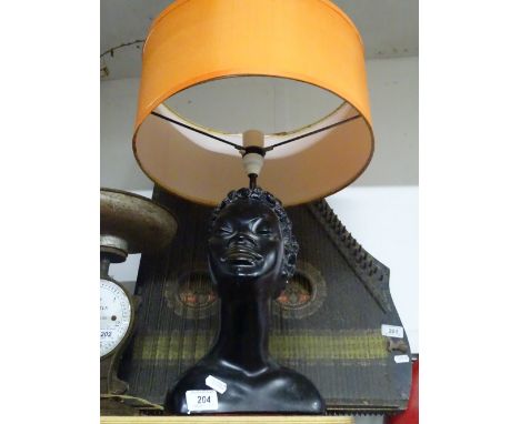 A plaster lady's head table lamp and shade.