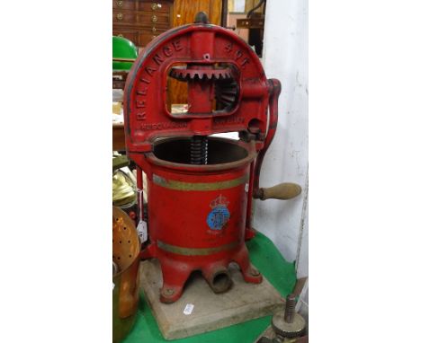 A cast-iron Husqvarna Reliance 4 quart apple press on stand.