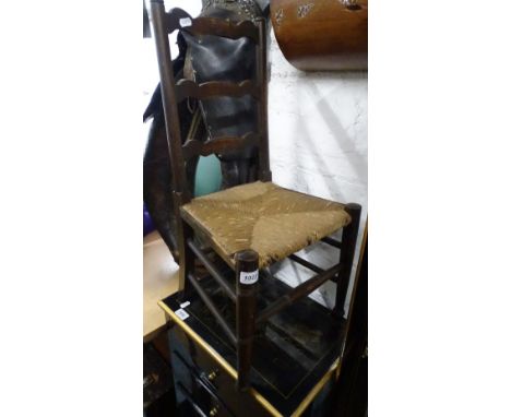 An Antique child's ladder back and rush seated chair.
