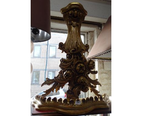 A large ornate painted and gilded plaster wall bracket.