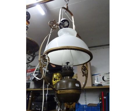 A hanging oil lamp with glass shade.