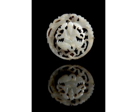 A white jade circular reticulated plaque set in a broochQing dynastyDepicting Shou Lao at the centreDiam.: 4 cm