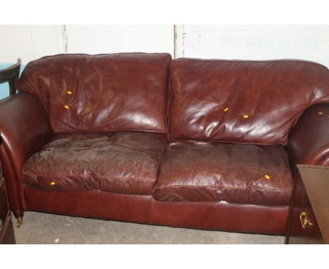 A LEATHER THREE SEATER SOFA