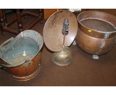 A LARGE COPPER COAL BUCKET RAISED ON CLAW FEET A/F, A COPPER COAL SCUTTLE AND VINTAGE COPPER PARAFFIN HEATER (3)