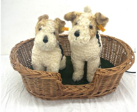 A Micheal Tallis creation of two automated Steiff fox terrier dogs in basket- in working order.  Measures approx 16 inches by