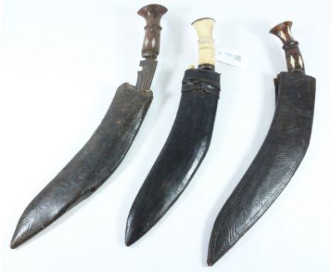 Nepalese Ghurka Kukri knife with bone hilt and and two small accompanying knives in leather scabbard 42cm overall; two other 